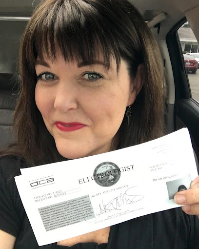 Hilary Molloy, Napa Electrologist and Esthetician, is holding her new Electrology license.